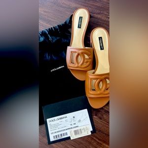 Dolce and Gabbana leather slide sandals.